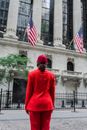 Woman in Red Coat Holding Us a Flag