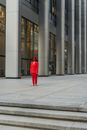Person in Red Coat Walking on Sidewalk