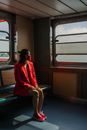 Woman in Red Jacket Sitting on Train Seat