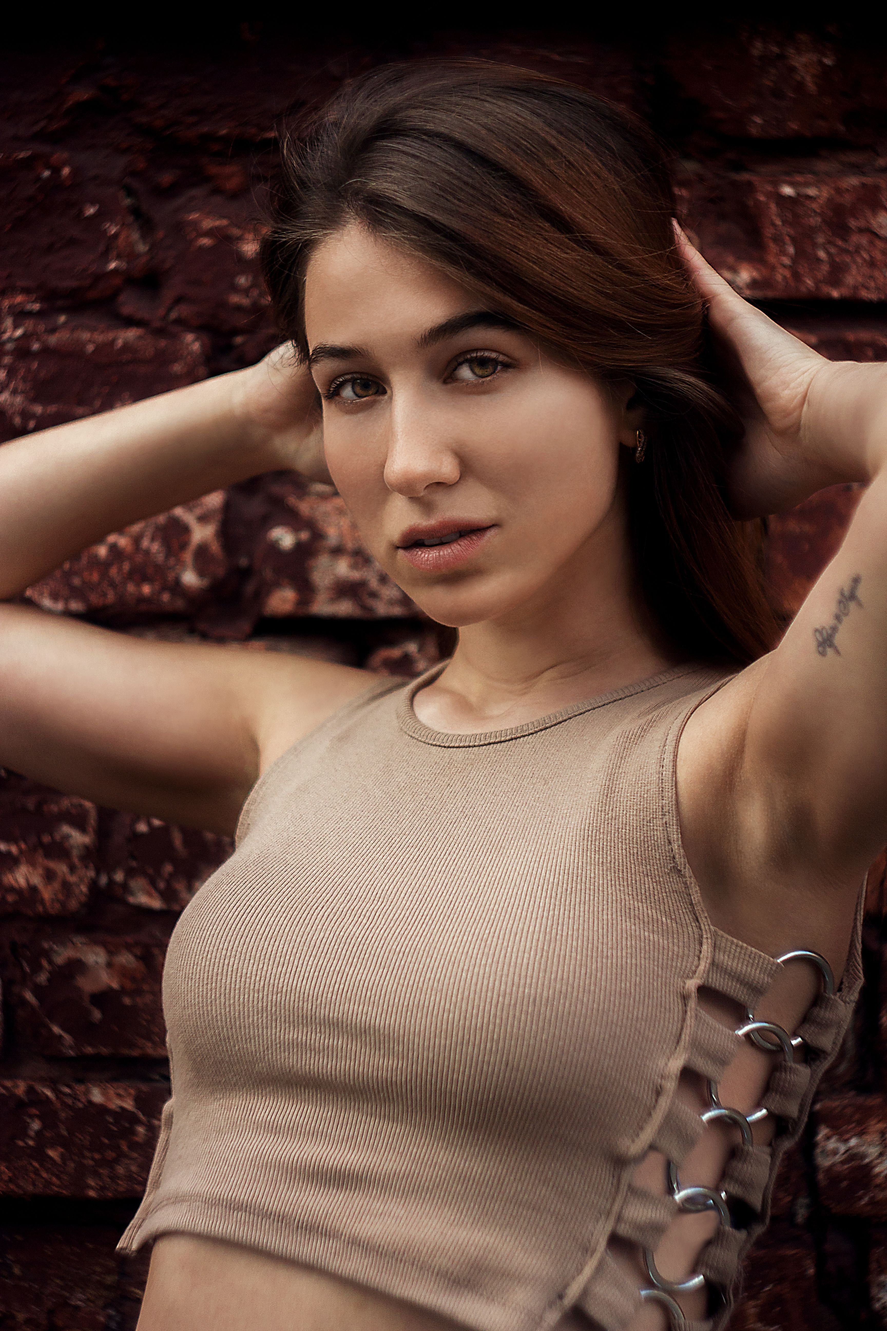 A Beautiful Woman in Beige Tank Top with Her Hands on Her Head · Free ...