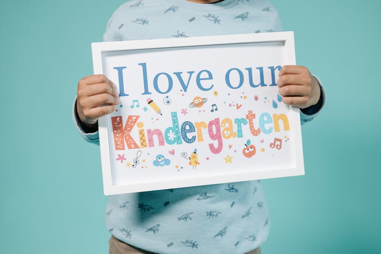 Kid Holding A Frame With A Message