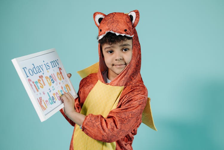 Boy Wearing Costume Holding A Placard