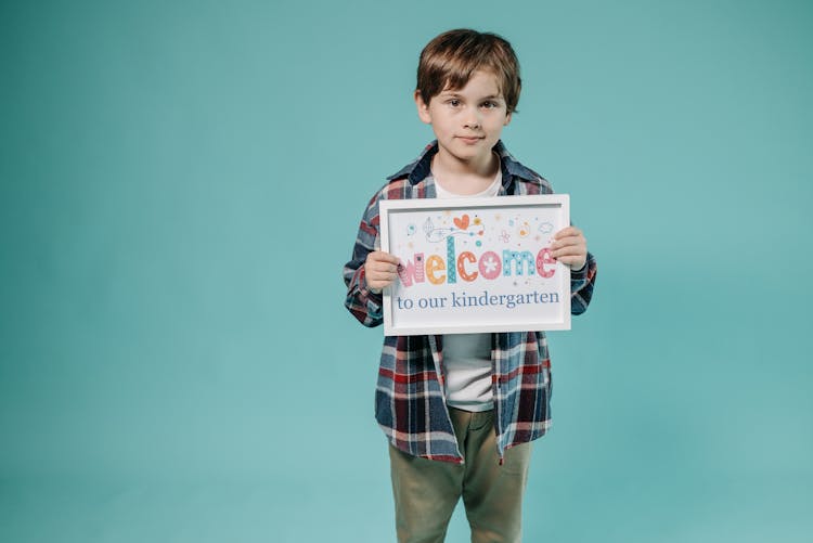 Boy Holding A Placard