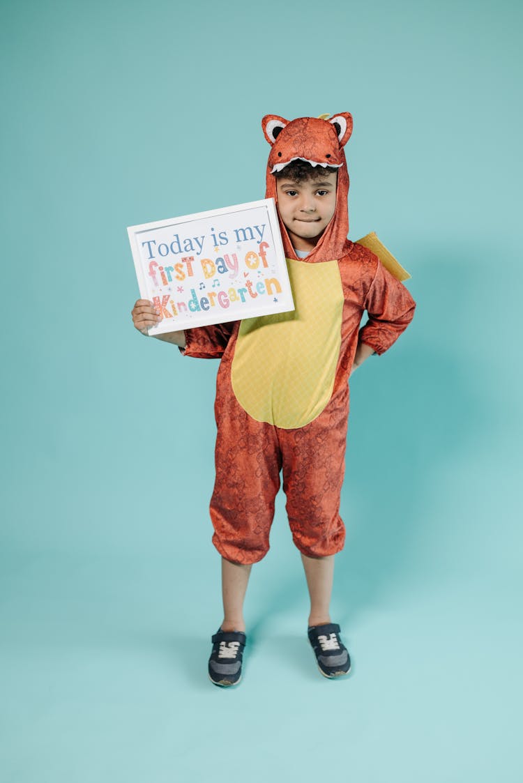 Kid Wearing Costume Holding A Placard