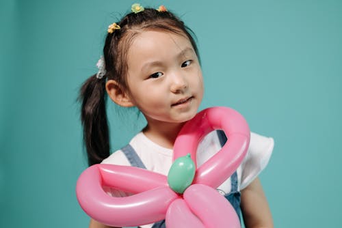 Girl Holding Pink Balloons