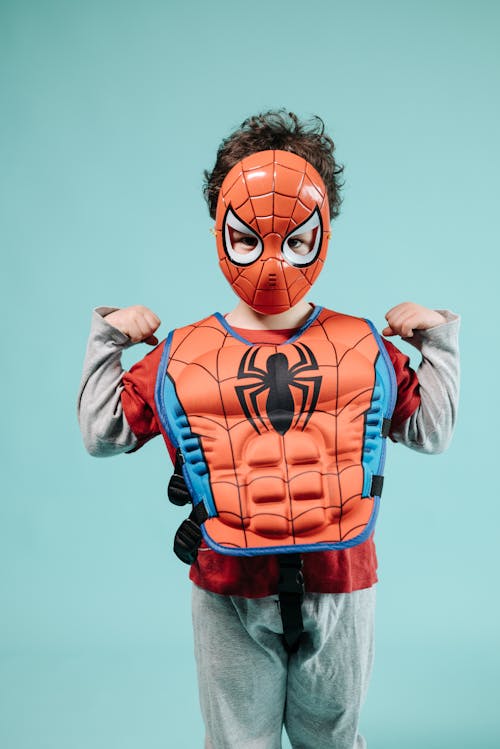 Boy in Red Costume Looking Sideways · Free Stock Photo