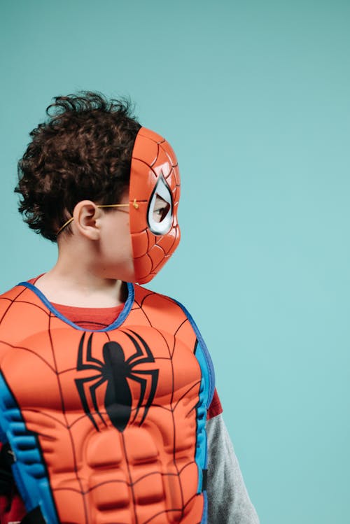 Free Boy in Red Costume Looking Sideways Stock Photo
