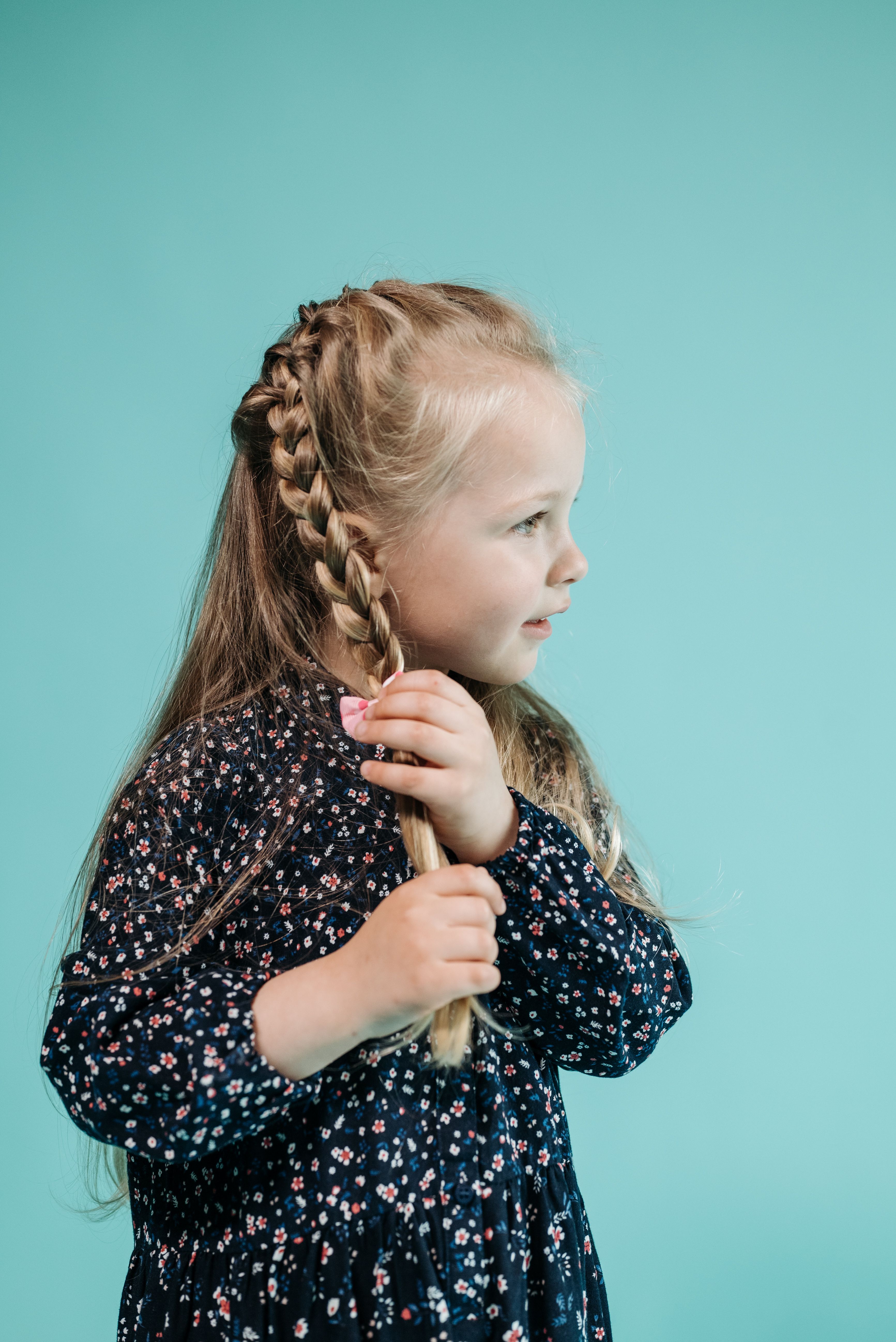 Girl in Floral Dress Touching Her Braided Hair · Free Stock Photo