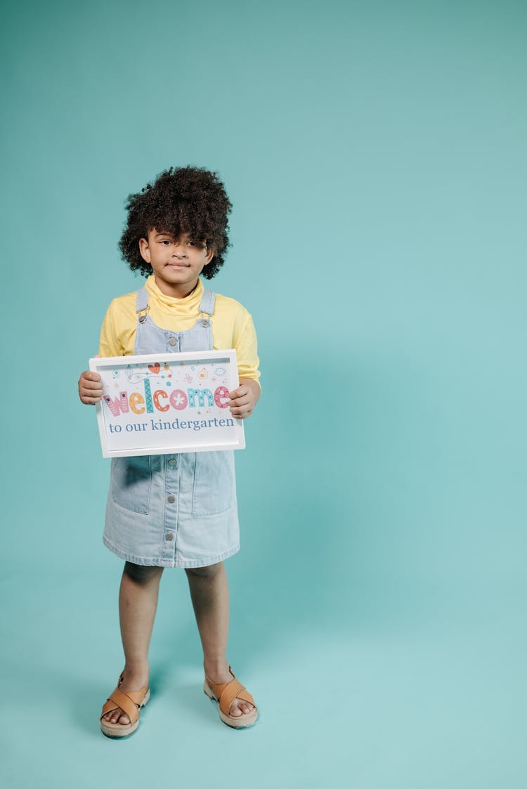 Kid With Afro Hair Holding A Placard