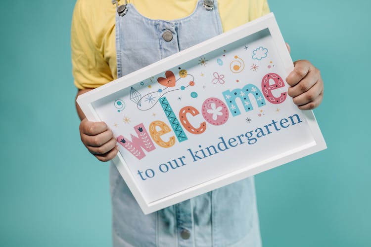 A Child Holding A Poster