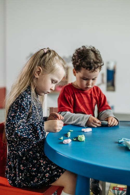 A Boy and Girl Playing Toys 