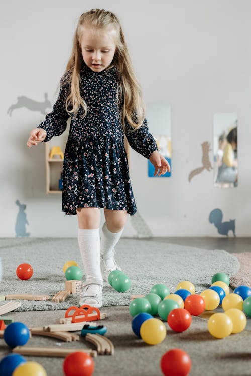 A Girl Playing Toys in the Room