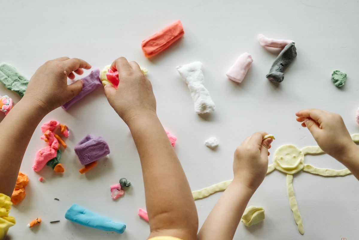 First birthday party favor ideas with children playing with colourful play-dough for play-dough jar favors