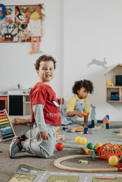 Free Boy in Red T-shirt Playing in Kindergarten Stock Photo