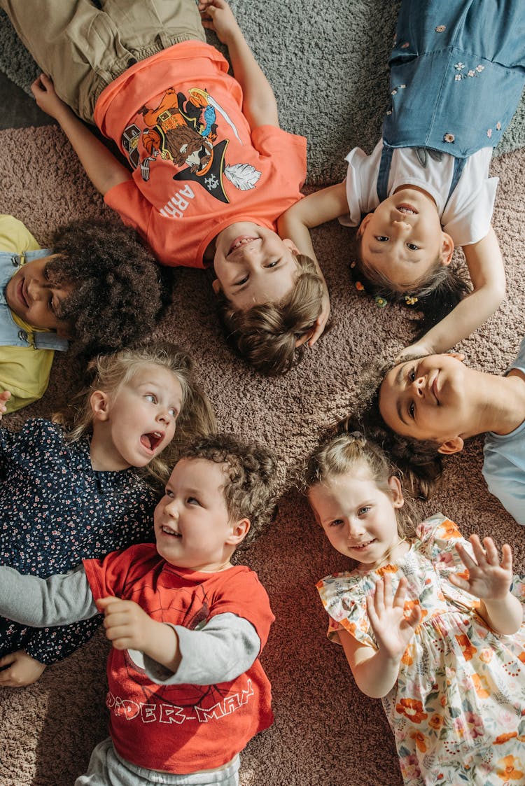 Kids Lying On The Carpet Floor