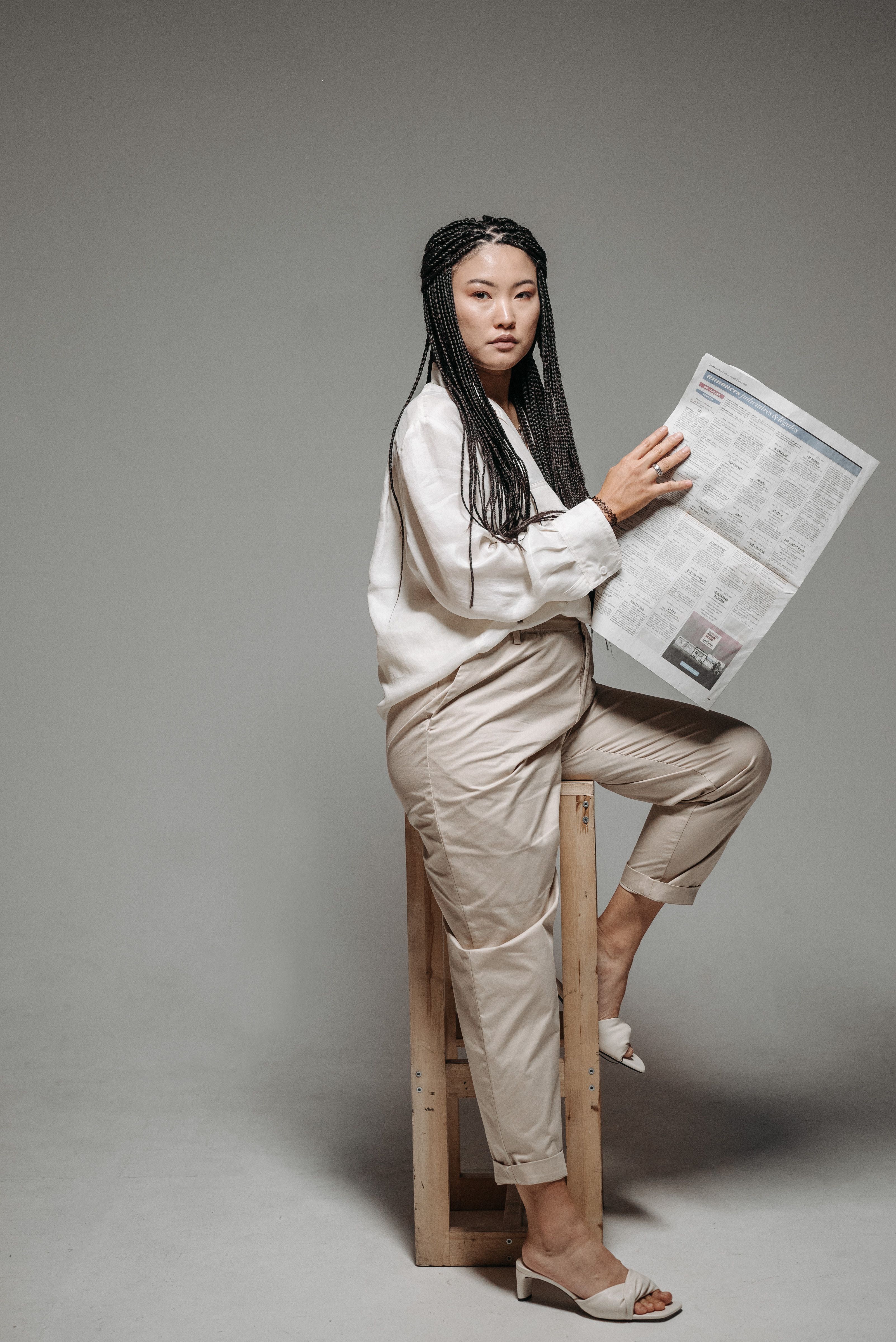 Woman in White Long Sleeve Shirt Sitting on Brown Wooden Chair · Free ...