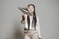 Woman in White Long Sleeve Shirt Holding Book
