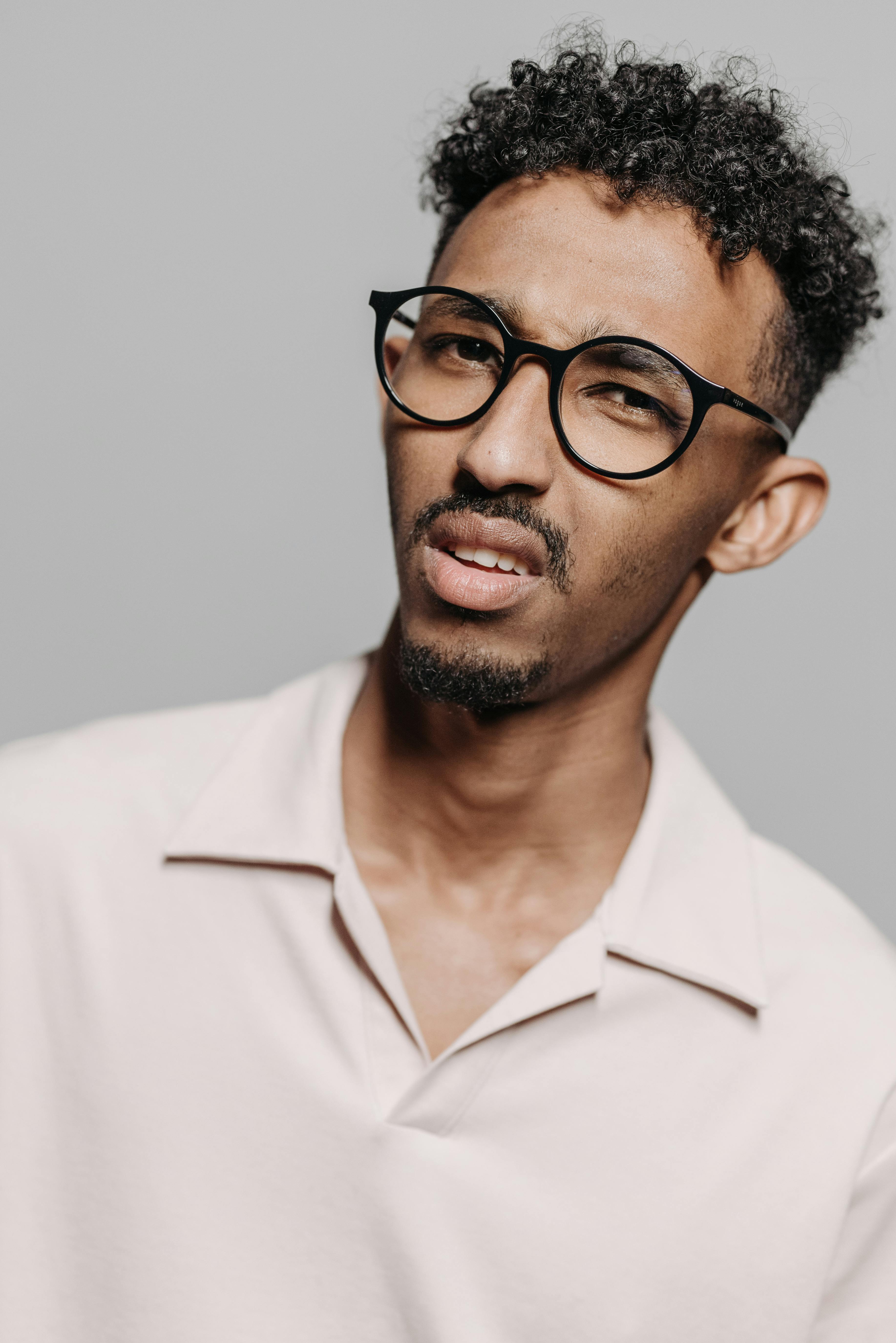 Man with Curly Hair Wearing Eyeglasses · Free Stock Photo