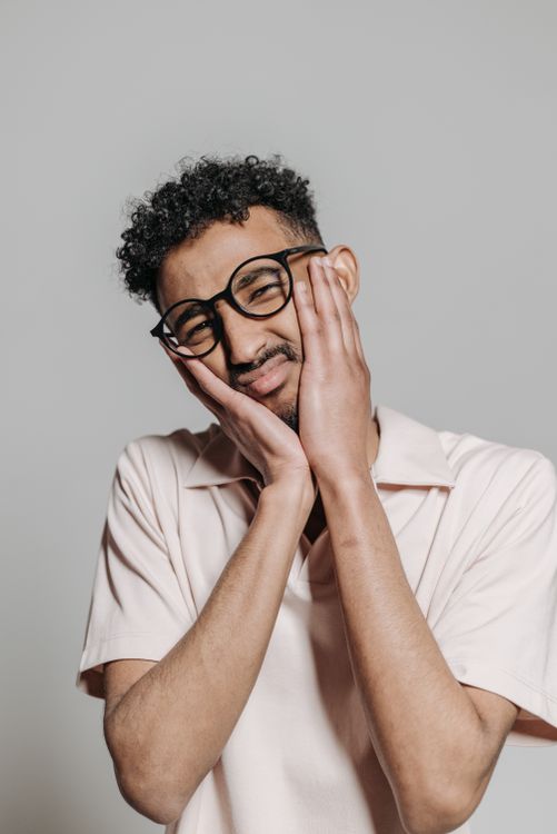 A Man Holding his Face · Free Stock Photo