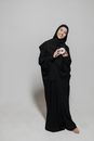 Woman in Black Hijab Standing Near White Wall