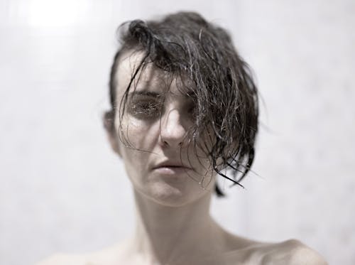 A Woman Face Covered Partially with Hair