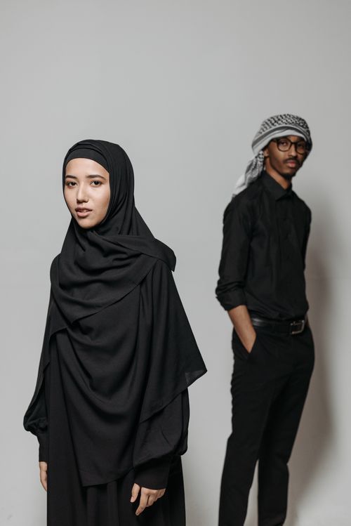 Free Studio shot of a man and woman in traditional clothing against a white background. Stock Photo