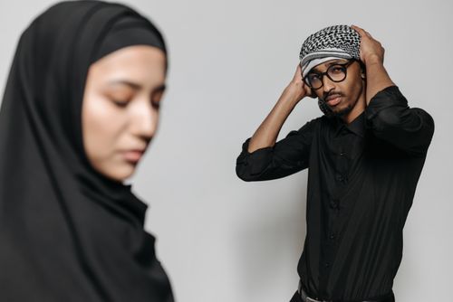 Free A modern studio portrait of a Muslim man and woman in traditional attire, showcasing cultural elegance. Stock Photo