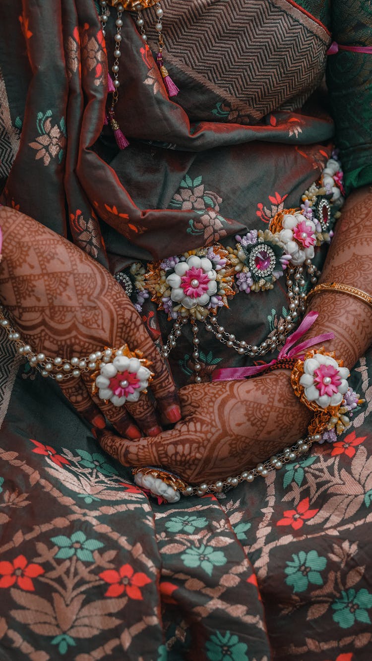 Close Up Of A Woman In Traditional Floral Dress And Mehendi Hand Tattoos