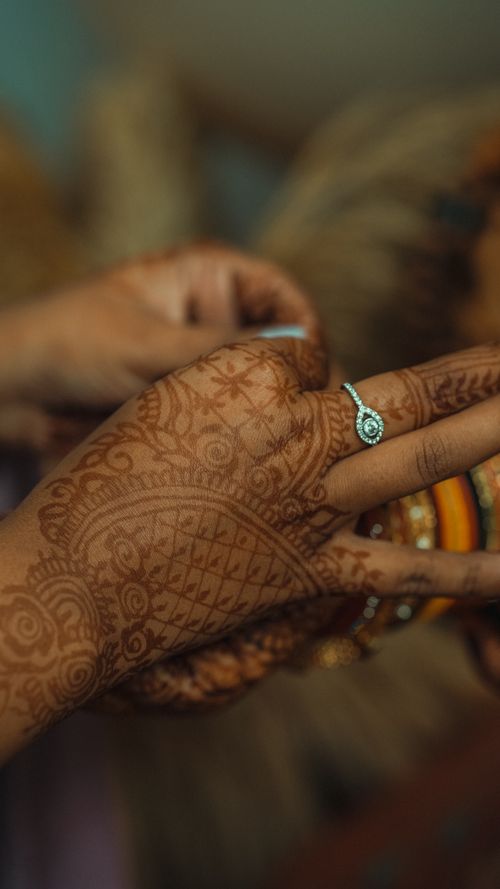 Free Close-up of an intricate henna design on a hand adorned with a ring, showcasing detailed body art. Stock Photo