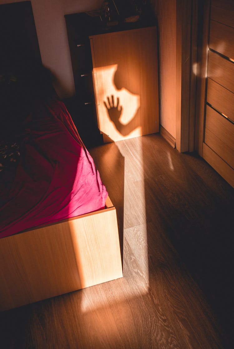 Shadow Of Person On A Bedroom 