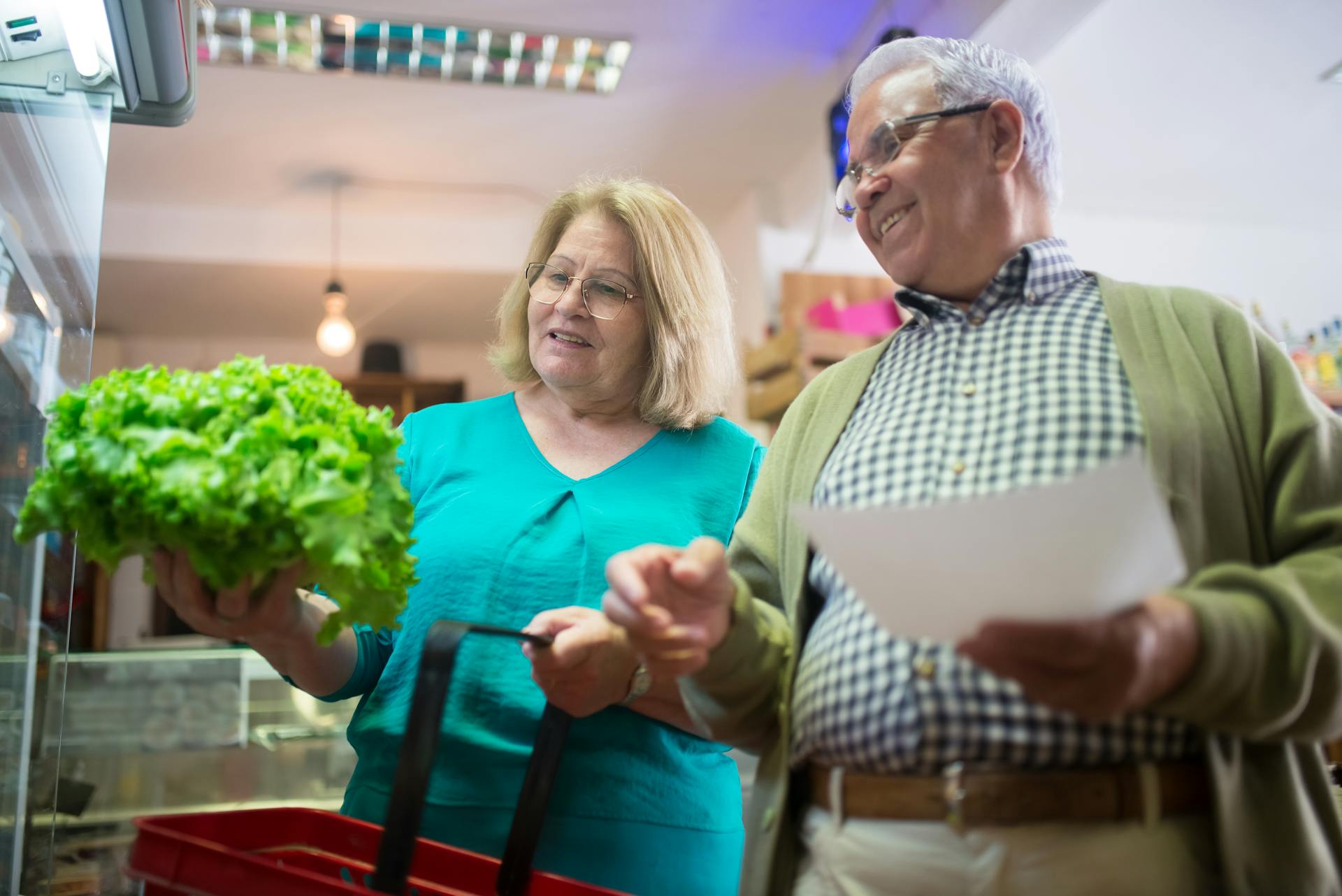 Elderly Couple Buying Vegetable in a Grocery Store