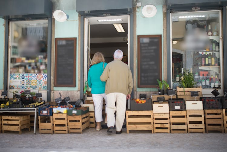 Backview Of An Elderly Couple Entering A Store 