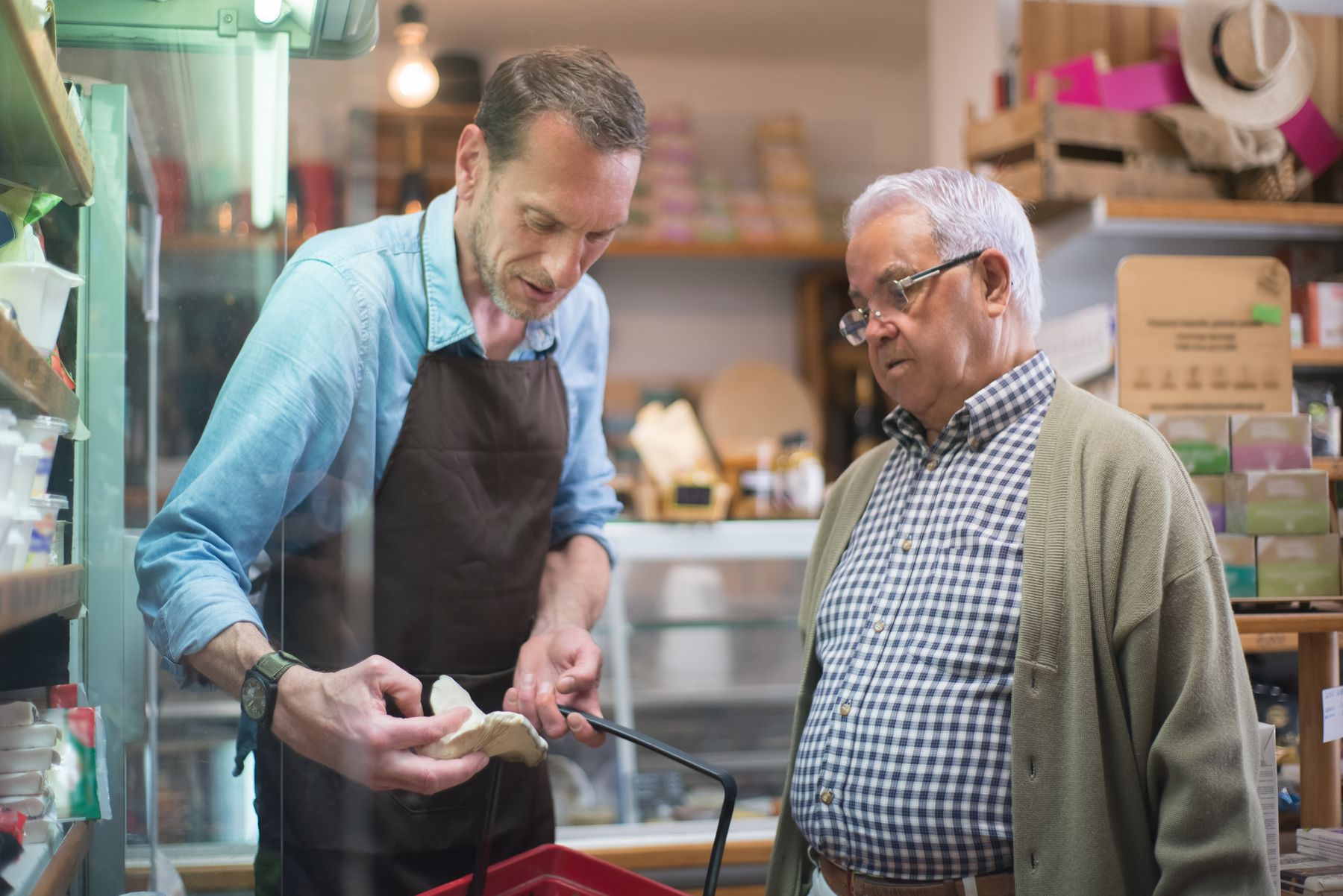 Store employee assisting a customer beside retail shelves