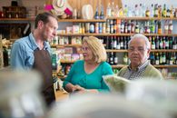 Selective Focus Photo of Elderly Couple Talking to the Store Clerk