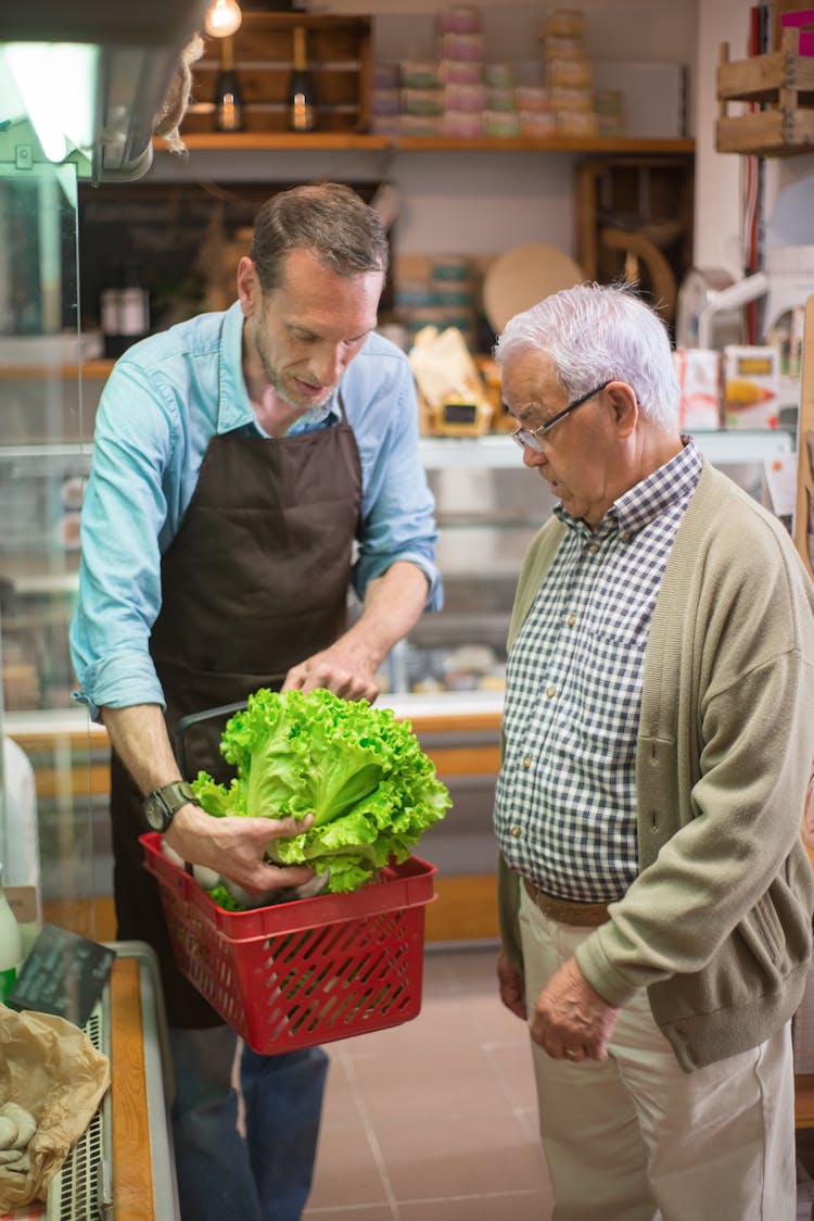 A Clerk Assisting The Elderly