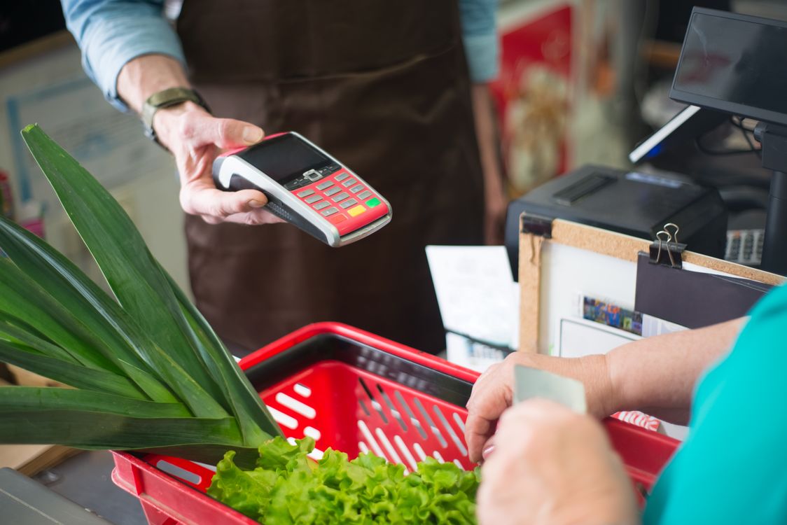 A Shopper Paying at the Counter · Free Stock Photo