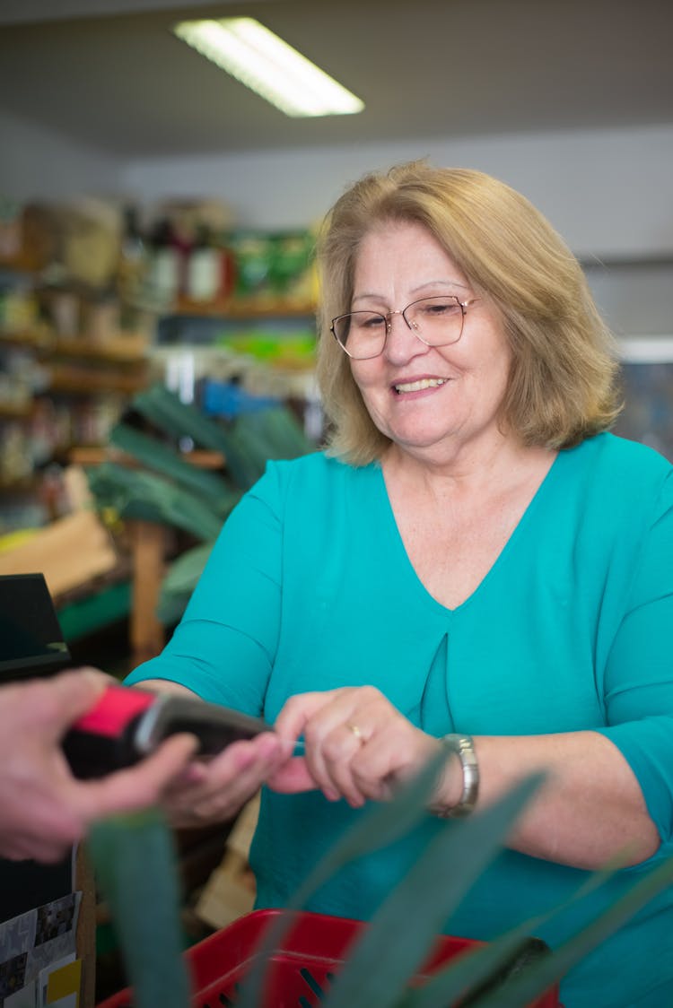 A Woman Paying For Her Groceries