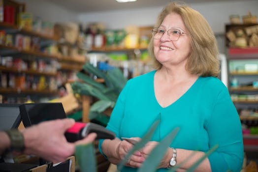 A happy senior woman making a purchase at a local store in Portugal.