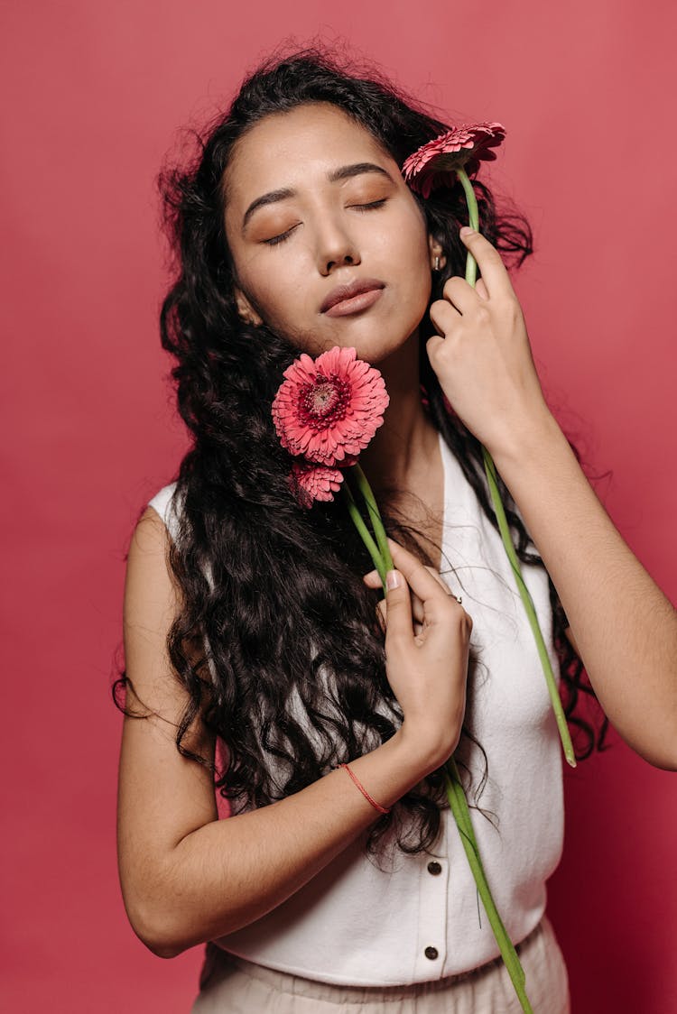 Woman With Dark Hair Holding Flowers