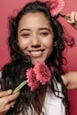 Woman Holding Red Flower Smiling