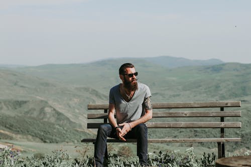 Free Photography of a Man Sitting on Wooden Bench Stock Photo