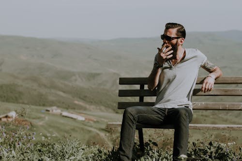 Free Photo of a Man Sitting on Wooden Bench Stock Photo