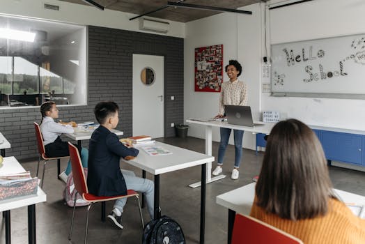 A modern classroom with a teacher and attentive students engaged in a lesson.