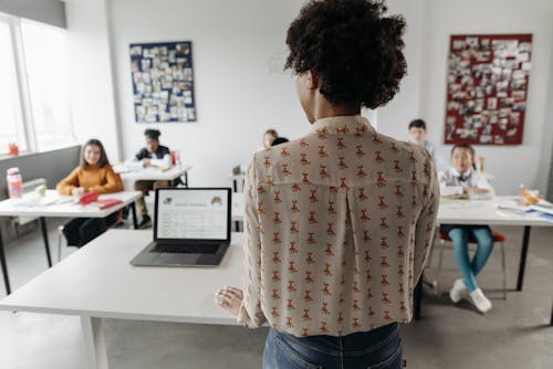 A Teacher Standing in Front of Her Students