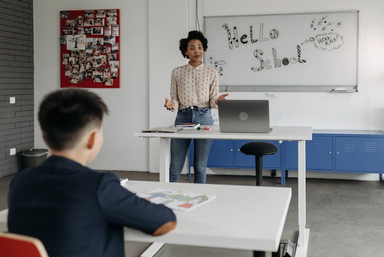 A Teacher Standing In Front Of The Class