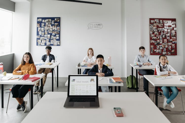 Students Inside A Classroom Listening Attentively 