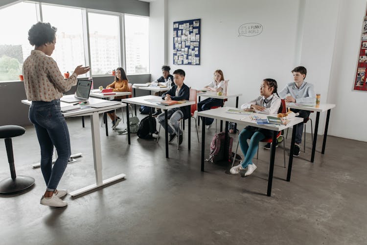 A Teacher And Students Inside A Classroom