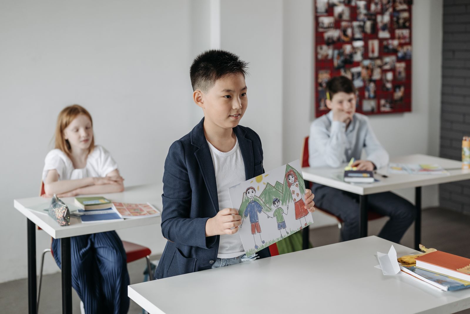 Pupil presenting work to classmates in a bright classroom
