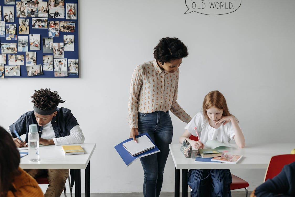 Free Teacher Checking on her Student Stock Photo