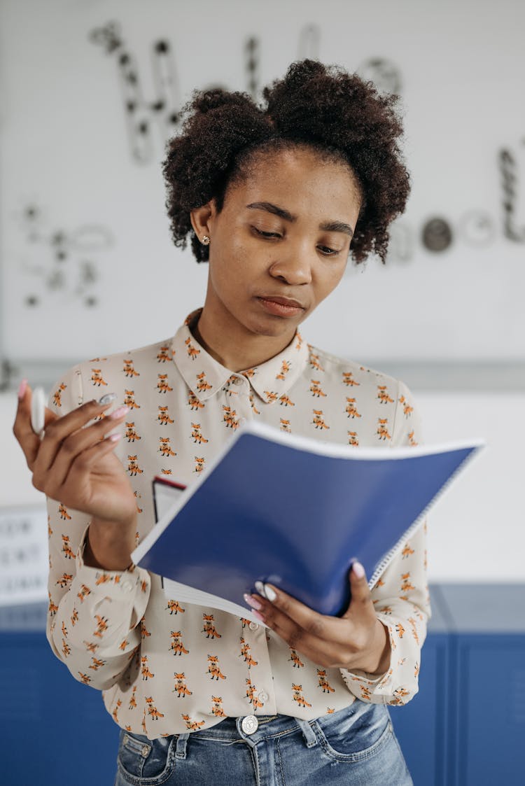 A Woman Reading From A Paper